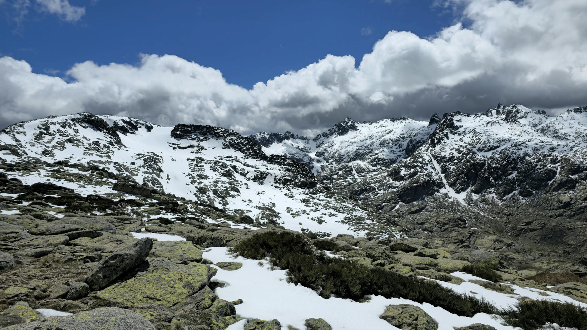 Breathtaking view of snowy Sierra de Gredos mountains under a vivid blue sky.