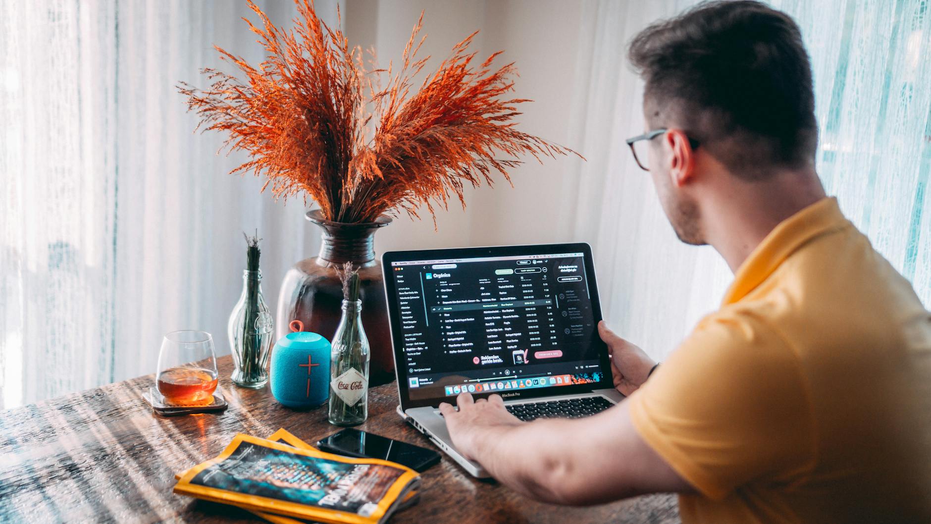 Man working from home with a laptop and vibrant decor in Istanbul. Ideal for remote work themes.