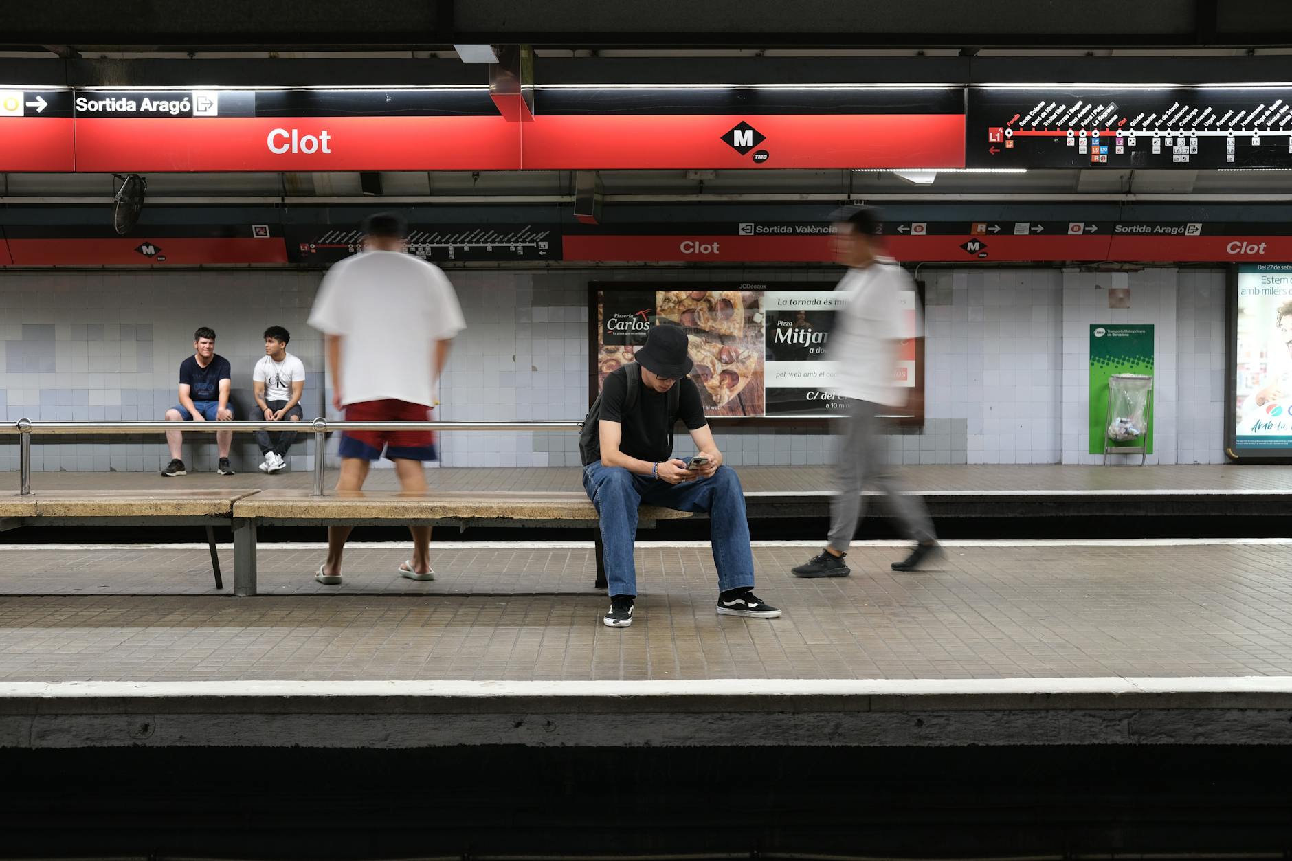 Candid scene of commuters at Clot Metro Station in Barcelona, capturing urban life dynamics.