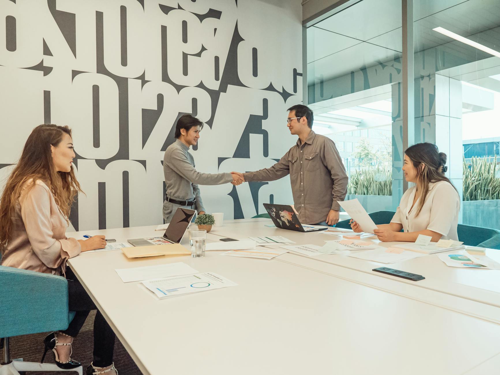 A diverse team of professionals discussing and collaborating in a modern office setting.