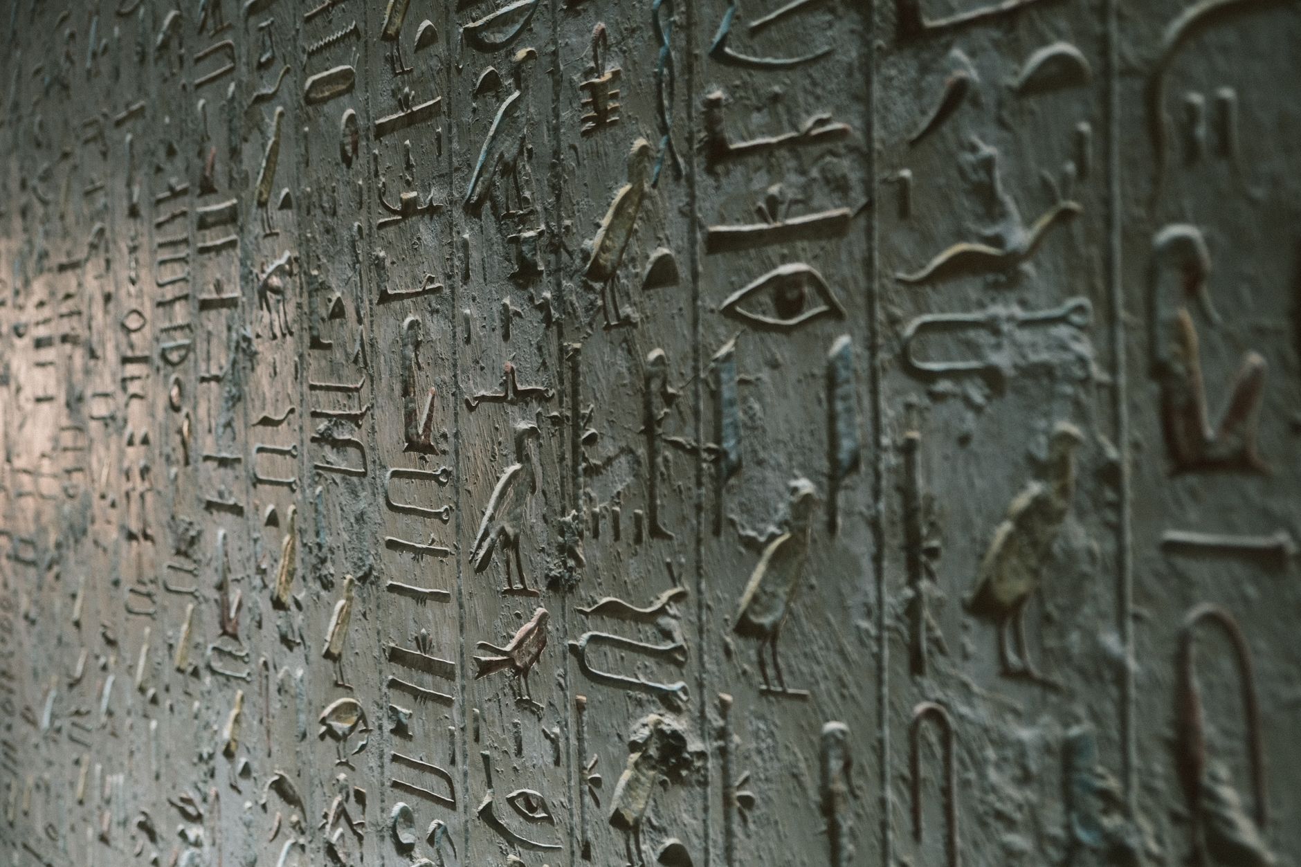 Detailed close-up of ancient Egyptian hieroglyphics on a stone wall in Luxor, Egypt.